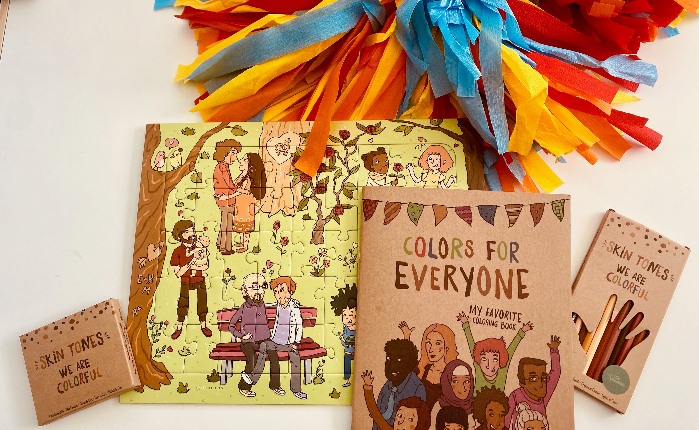 Schooling gift: drawing set with diverse skin tones pencils, crayons, coloring books, and a puzzle.