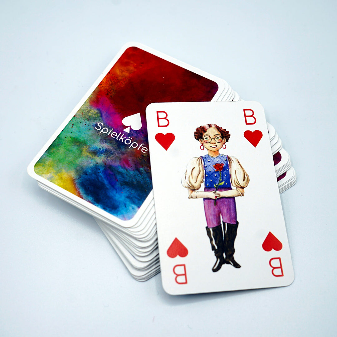 Ein Stapel "Spielköpfe" Kinderkarten mit aufgedeckter Herz Bube Karte.